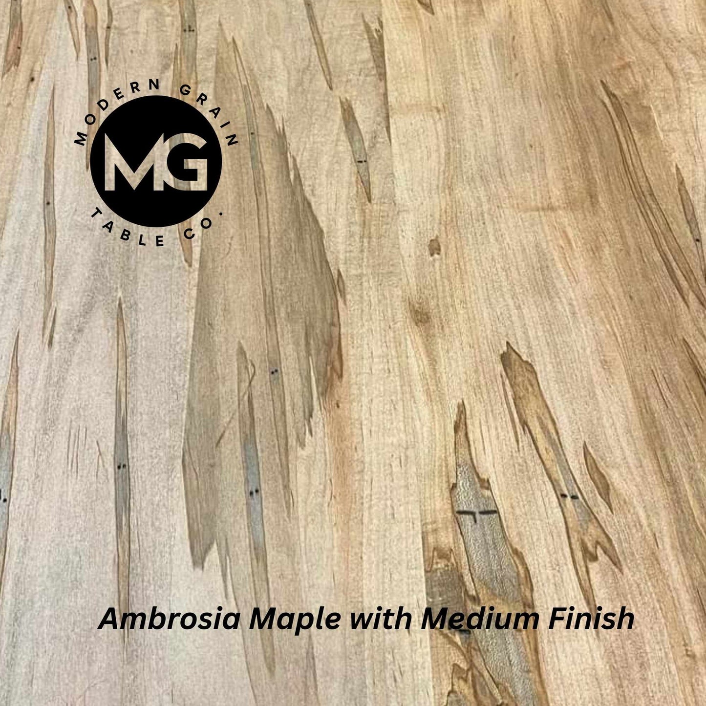 Close-up of Ambrosia Maple hardwood with soft grain lines and natural tone variation