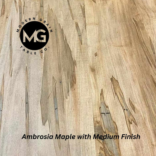 Close-up of Ambrosia Maple hardwood with soft grain lines and natural tone variation