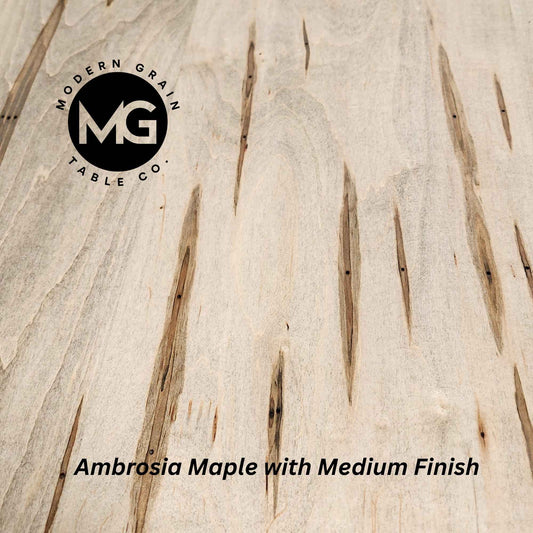 Ambrosia Maple table surface close-up highlighting organic character and flowing grain pattern