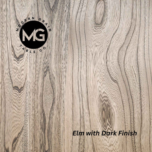 Close-up of Elm hardwood with Dark finish from Modern Grain Table Co., highlighting dramatic grain patterns, rich tone, and natural wood texture.