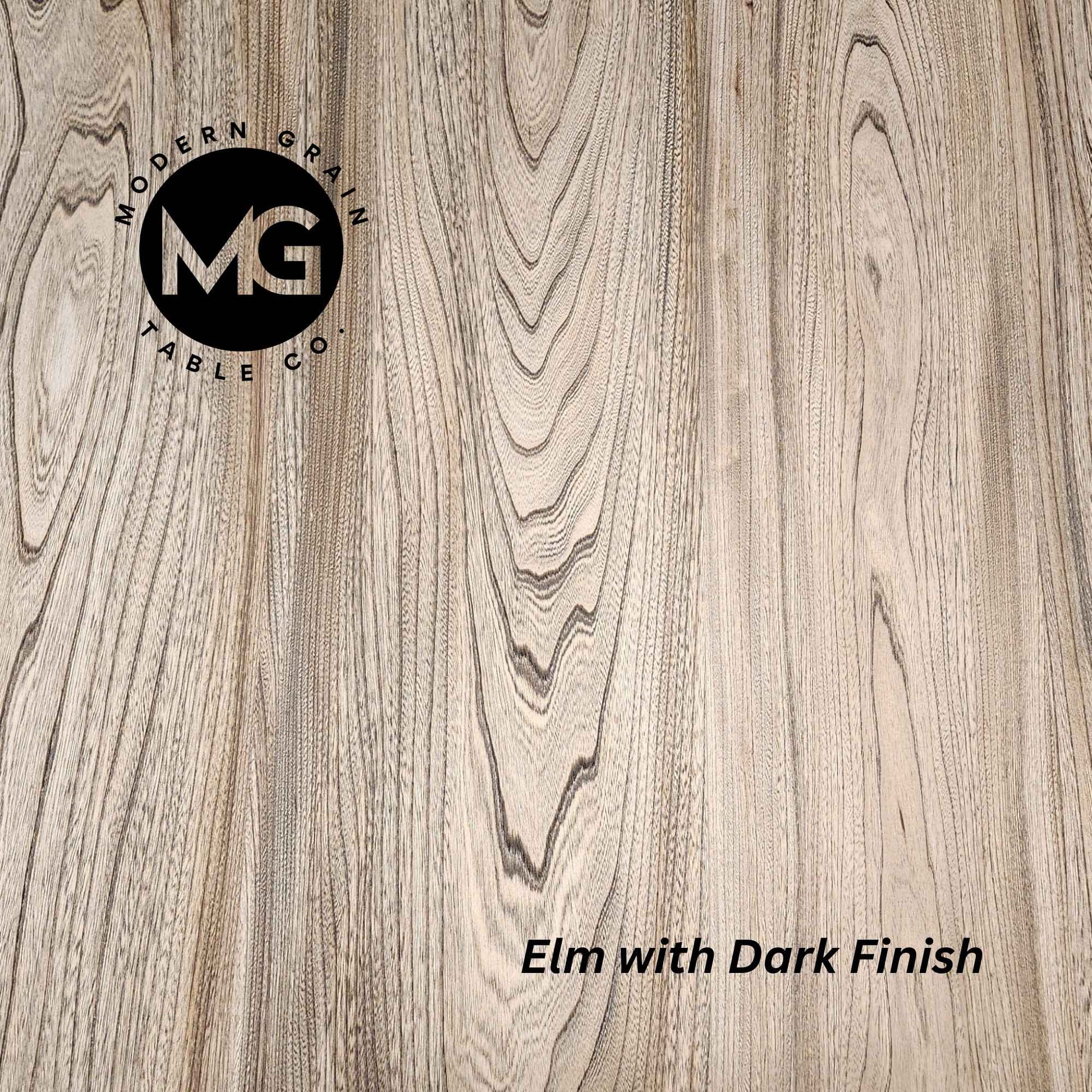Detailed close-up of Elm hardwood with Dark finish from Modern Grain Table Co., showing bold grain movement and deep, natural contrast.