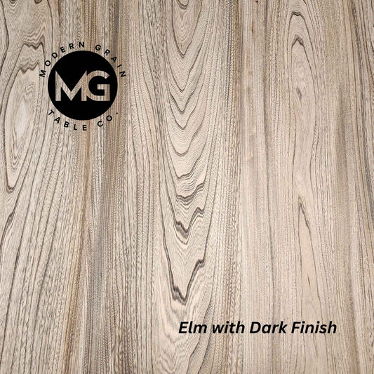 Detailed close-up of Elm hardwood with Dark finish from Modern Grain Table Co., showing bold grain movement and deep, natural contrast.
