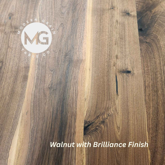 Close-up of Walnut hardwood with Brilliance finish from Modern Grain Table Co., showcasing rich brown tones, natural grain depth, and a smooth matte sheen.
